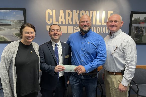 Town Manager Kevin Baity and Town Council President Ryan Ramsey present a check to Pastor Jim Moon and Meredith Rodriguez of the Catalyst Rescue Mission.