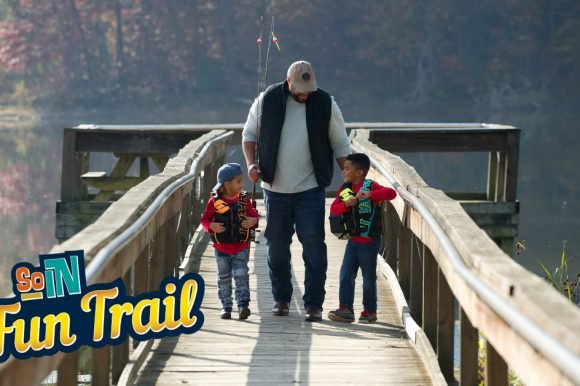 Dad fishing with two sons.